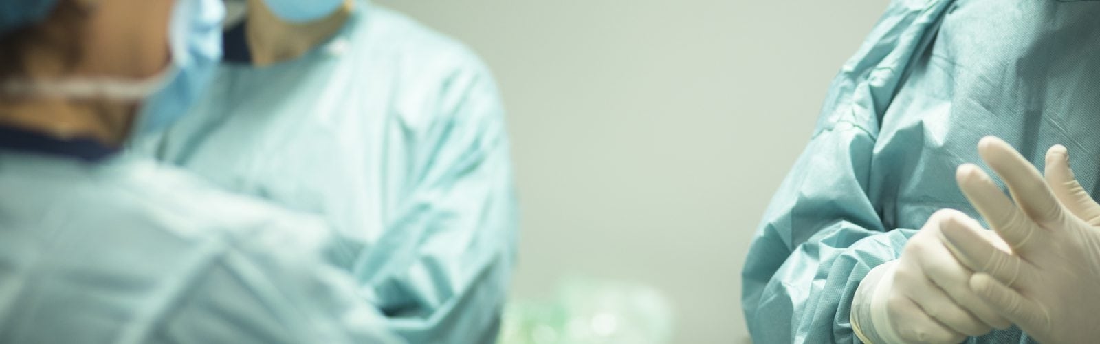 Surgeon in hospital surgery in sterile uniform "scrubs" in operating theater emergency room in surgical operation.