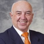 photo of Dr. Hans Sollinger from the shoulders up, in a dark suit, white shirt and orange tie