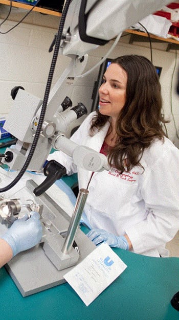 researcher using Microscope
