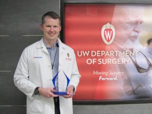 Dr. Shahan holding his award