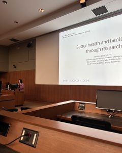 Dean Wong stands at a podium at the front of an auditorium