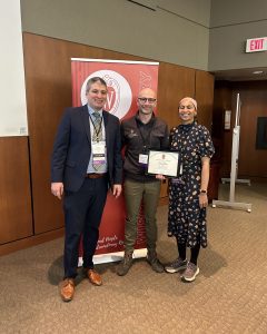 Drs. Patrick Varley, David Harris, and Mehreen Kisat stand in front of a banner that says "Wisconsin Surgery"