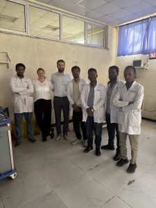 Dr. Miloš Buhavac and Dr. Andrea Weitz stand with five other doctors wearing white coats. 