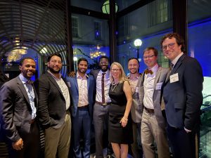 Desmond Layne, Aahad Khan, Dev Joshi, Dawda Jawara, Ann O'Rourke, Michael Stellon, Steven Morrison, and Clayton Marcinak stand together for a picture