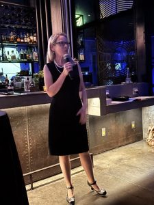 Dr. Ann O'Rourke holding a microphone